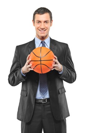 OHare-Smiling-Businessman-Holding-A-Basketball-800